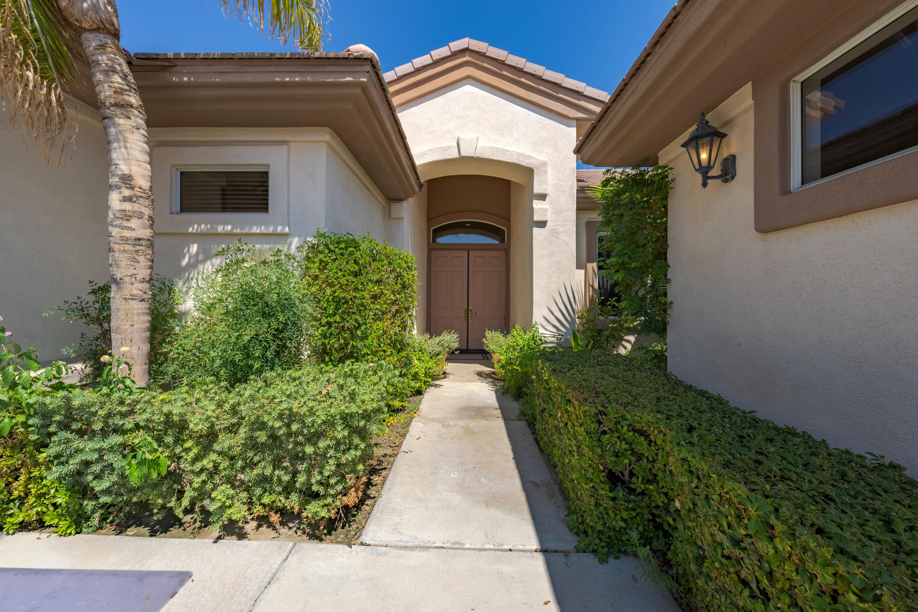 37384 Wyndham Road Palm Desert, CA 92211 - Photo 7 of 30 a view of a house with potted plants