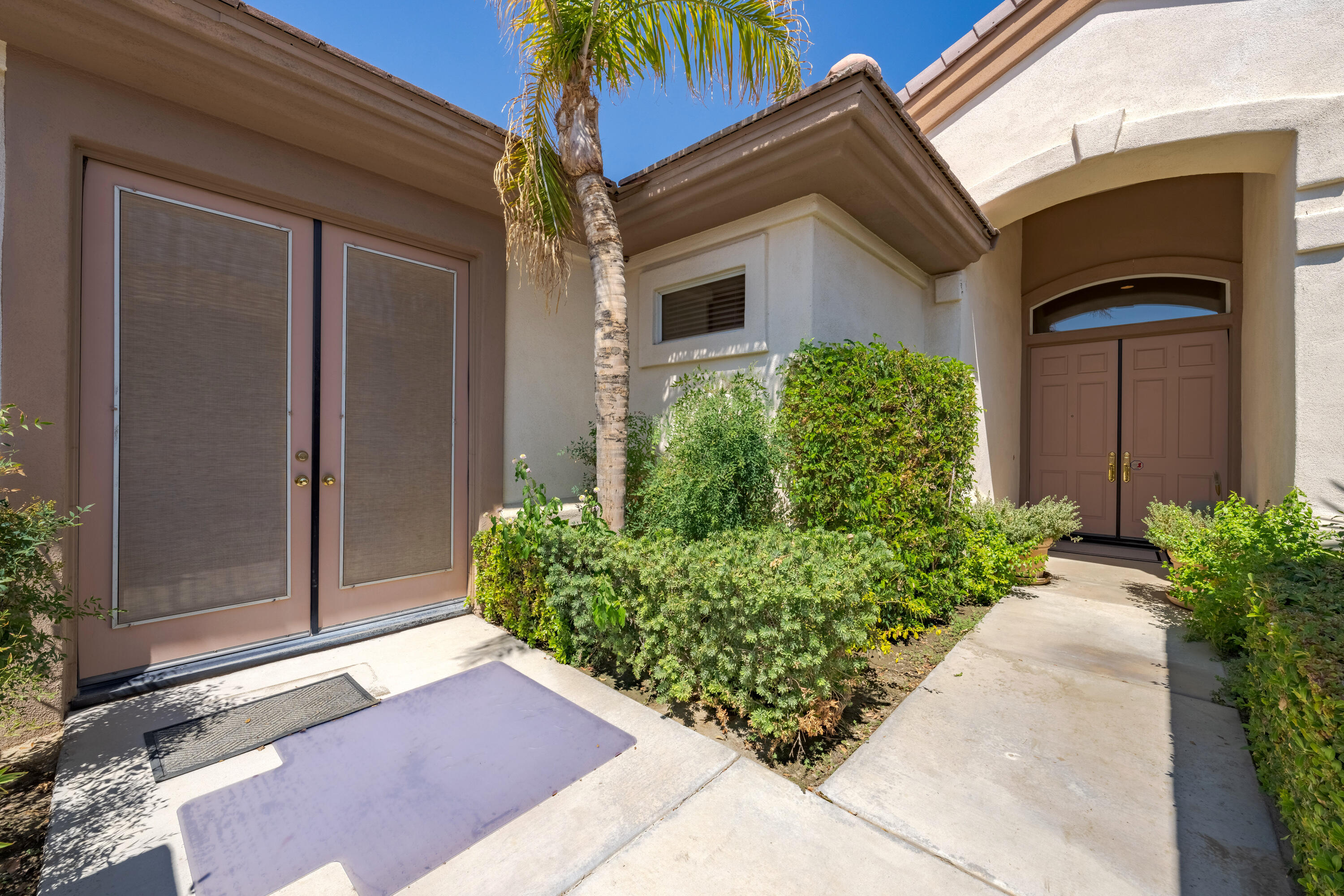 37384 Wyndham Road Palm Desert, CA 92211 - Photo 8 of 30 a front view of a house with a yard