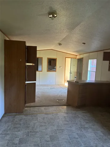 an empty room with closet and windows