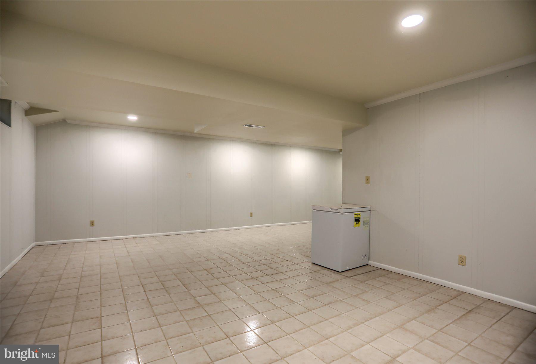 10902 Baronet Road Owings Mills, MD 21117 - Photo 34 of 42 an empty room with white walls and tiles