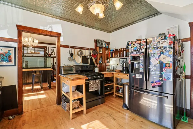 a kitchen with stainless steel appliances granite countertop a refrigerator and a stove top oven