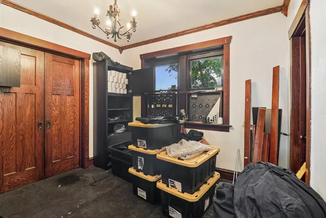 a living room with furniture a chandelier and a window