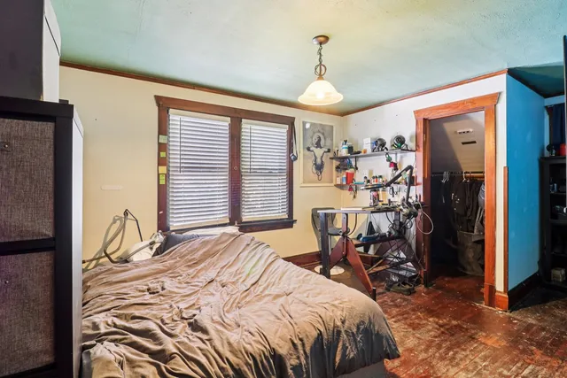 a bedroom with a bed and a chandelier