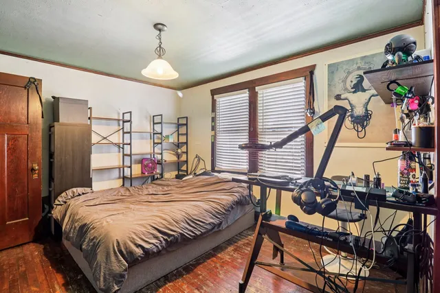 a bed room with a bed and a chandelier