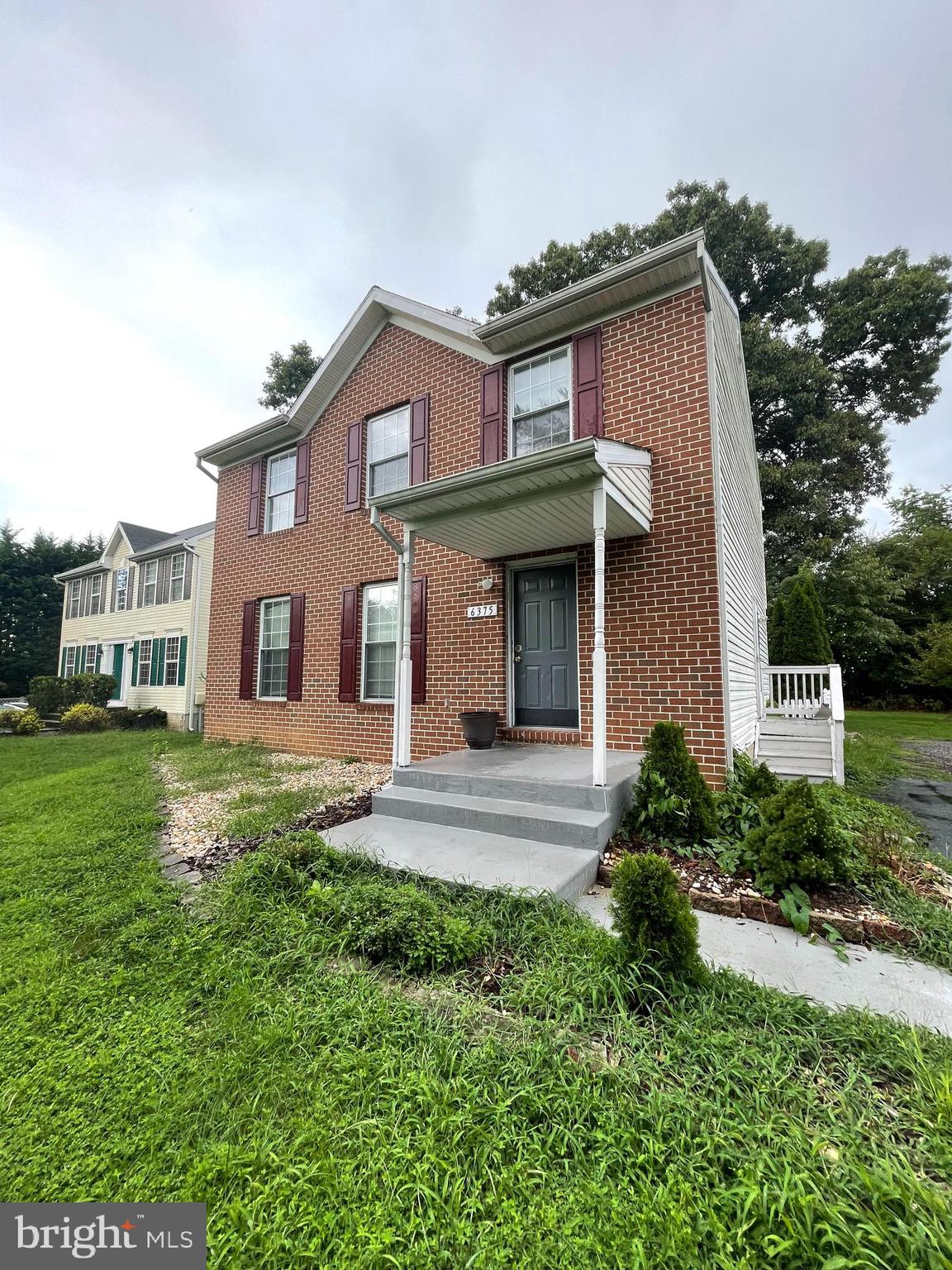6375 Waterloo Road Elkridge, MD 21075 - Photo 1 of 18 a view of a white house next to a yard with big trees
