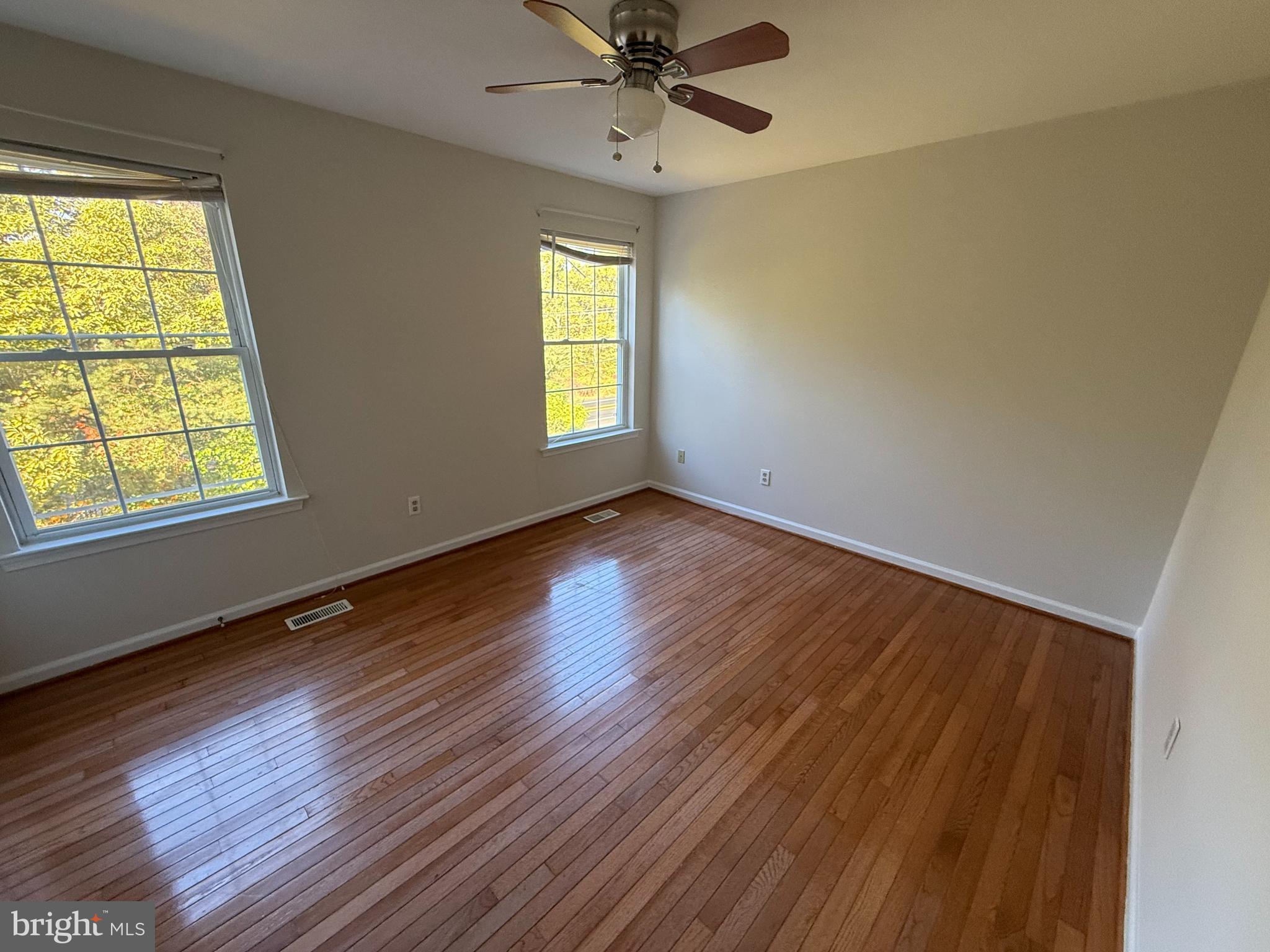 6375 Waterloo Road Elkridge, MD 21075 - Photo 11 of 18 a view of an empty room with wooden floor and a window