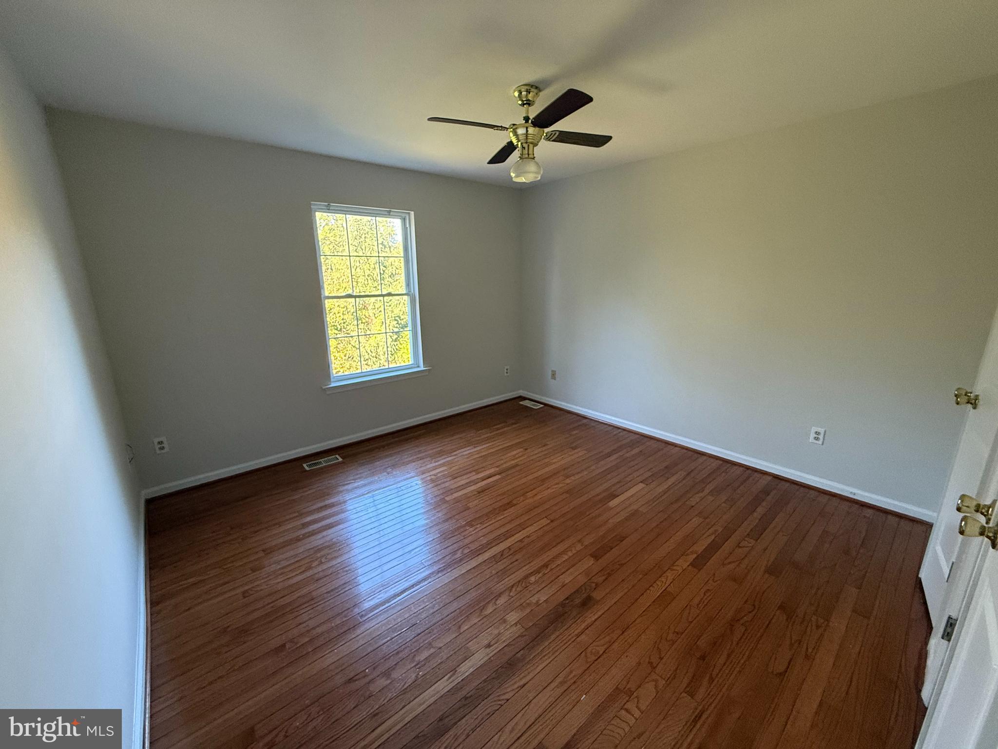 6375 Waterloo Road Elkridge, MD 21075 - Photo 12 of 18 a view of empty room with wooden floor and fan