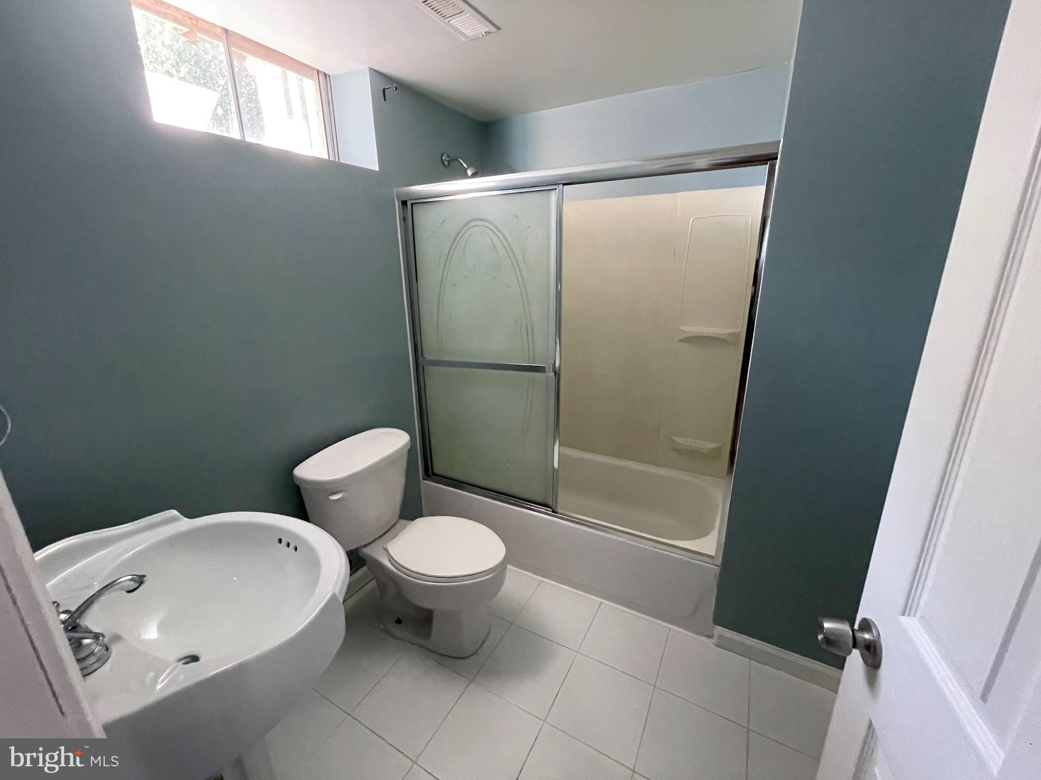 6375 Waterloo Road Elkridge, MD 21075 - Photo 16 of 18 a bathroom with a toilet and a shower