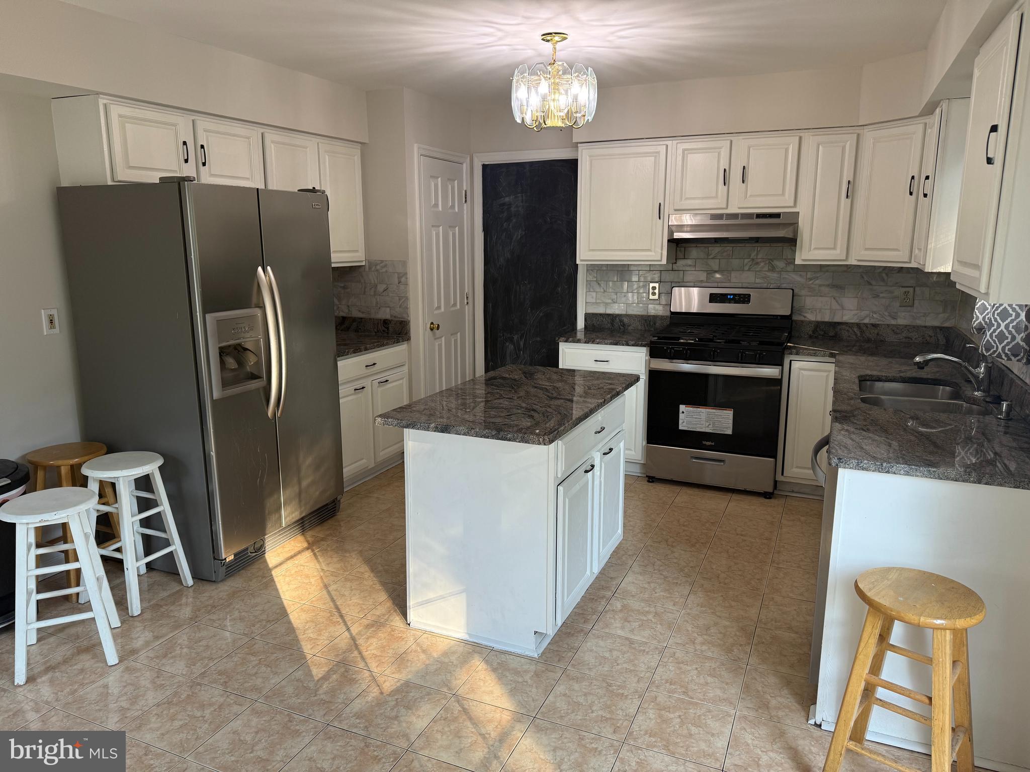 6375 Waterloo Road Elkridge, MD 21075 - Photo 2 of 18 a kitchen with granite countertop a refrigerator stove and sink