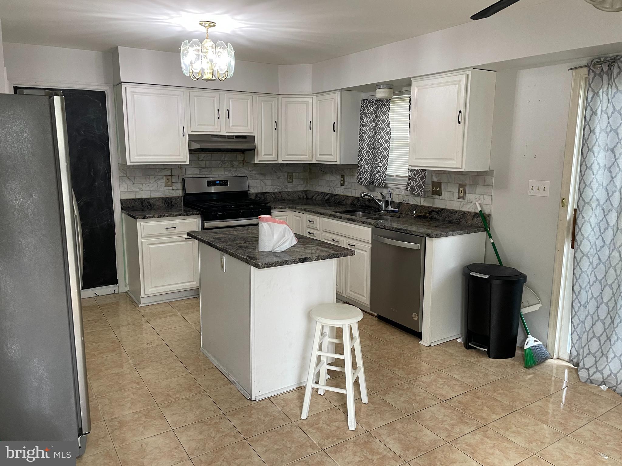 6375 Waterloo Road Elkridge, MD 21075 - Photo 3 of 18 a kitchen with a sink stove and refrigerator