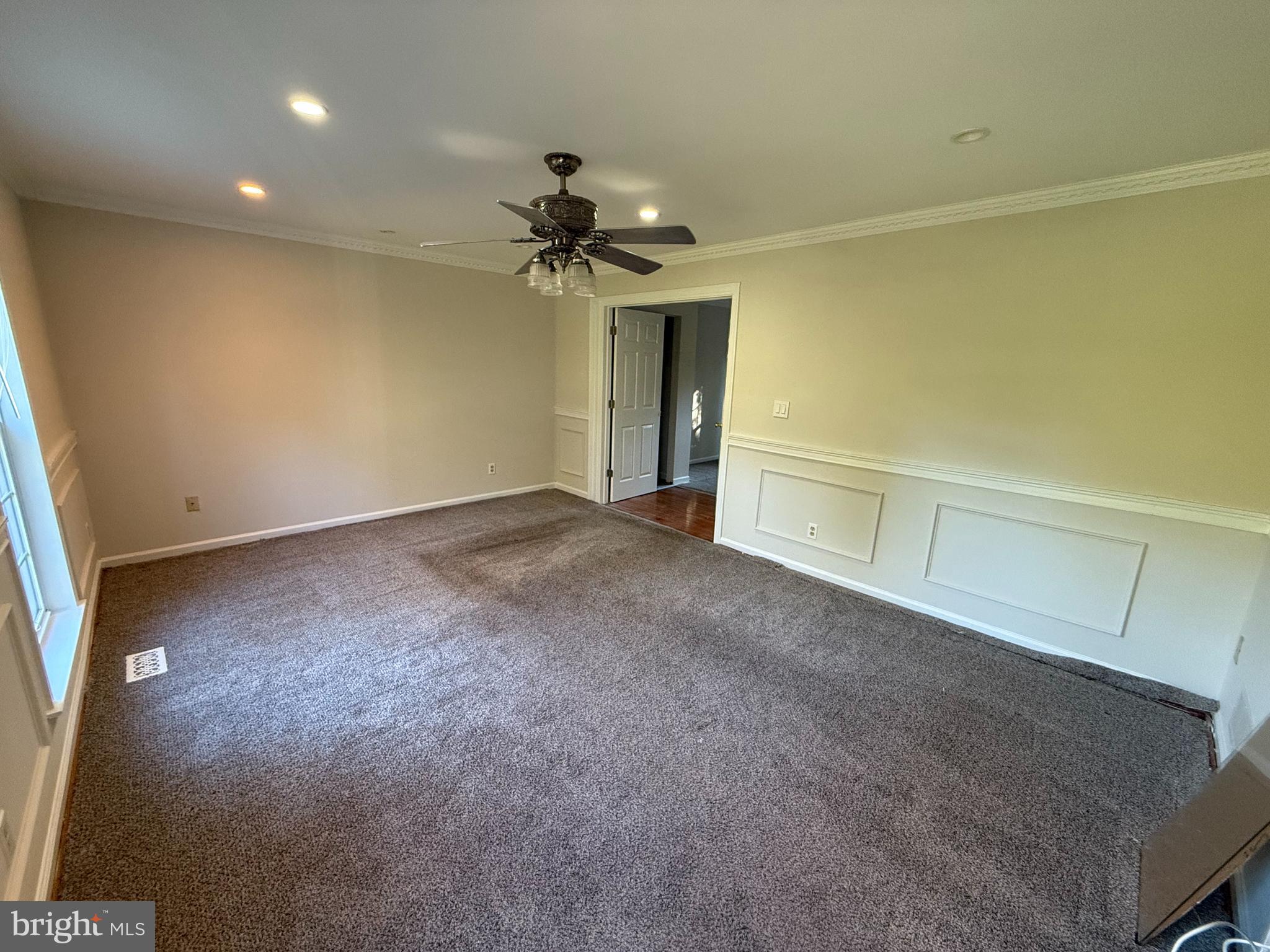 6375 Waterloo Road Elkridge, MD 21075 - Photo 4 of 18 an empty room with a ceiling fan and a window