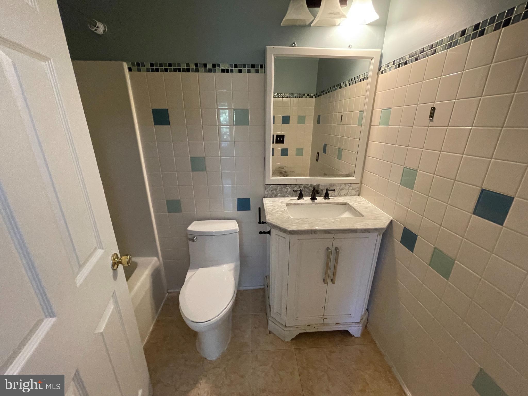 6375 Waterloo Road Elkridge, MD 21075 - Photo 6 of 18 a bathroom with a sink a toilet and shower