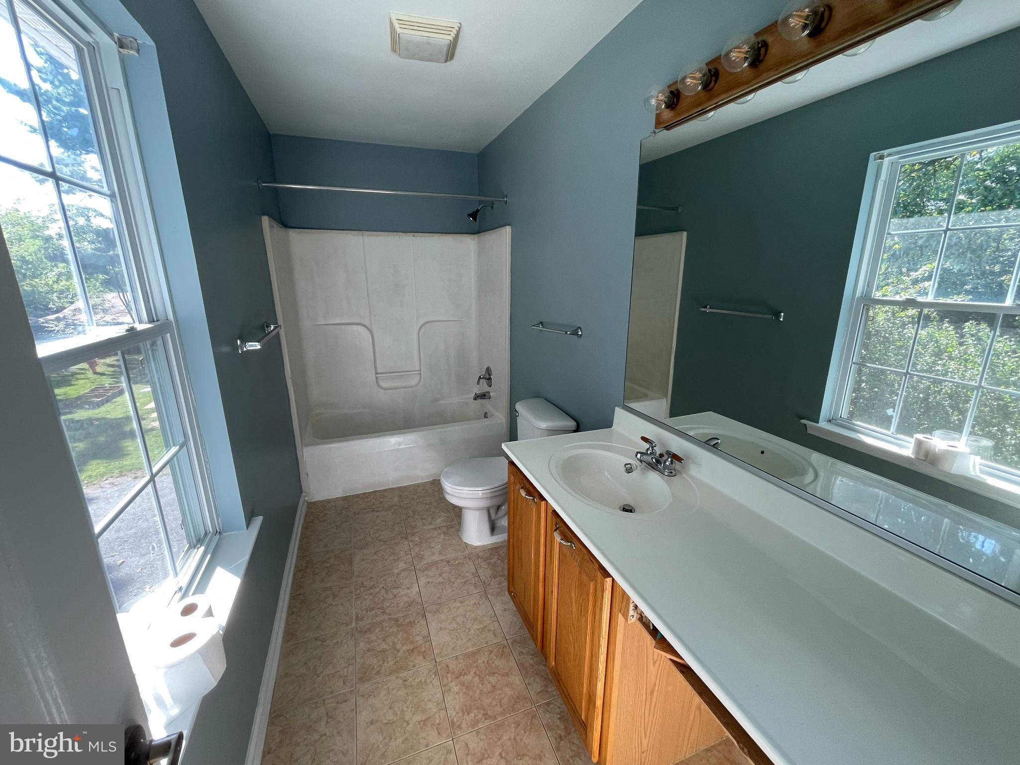 6375 Waterloo Road Elkridge, MD 21075 - Photo 9 of 18 a spacious bathroom with a double vanity sink and a large mirror
