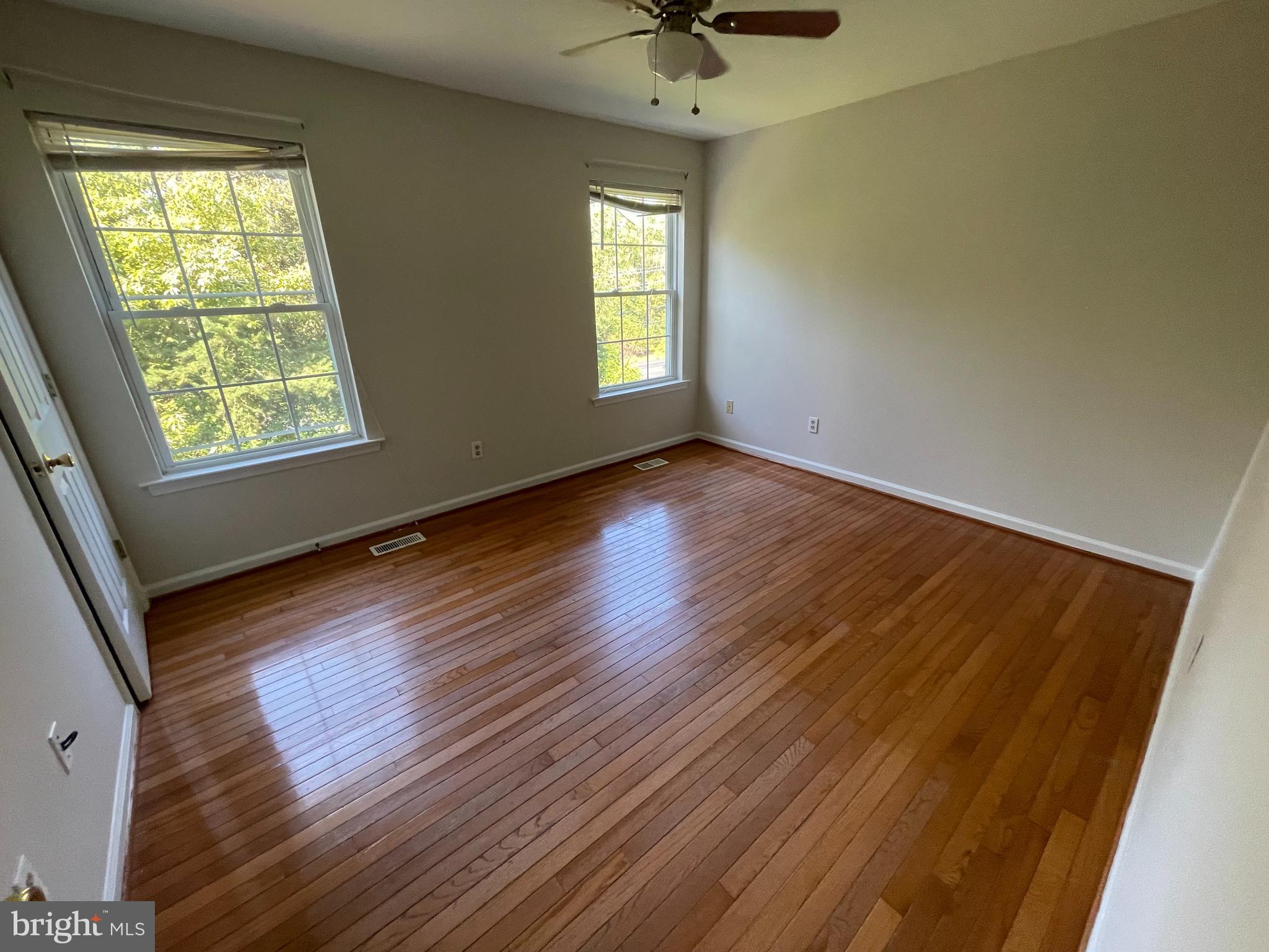 6375 Waterloo Road Elkridge, MD 21075 - Photo 10 of 18 a view of an empty room with wooden floor and a window