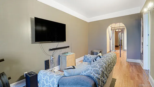 a bedroom with furniture and a large window