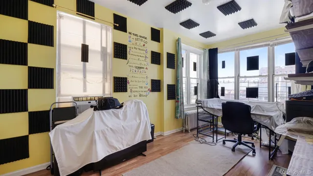 a view of a hallway with wooden floor and a chandelier