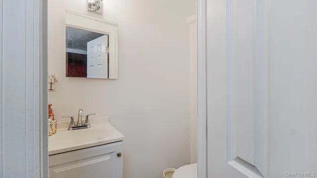 a bathroom with a sink a toilet and curtain