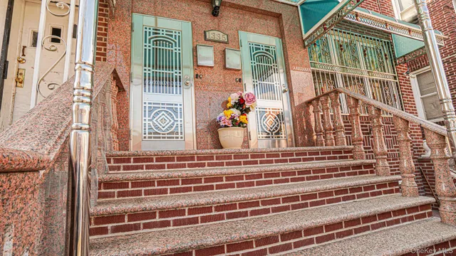 a living room with furniture a flat screen tv and kitchen view