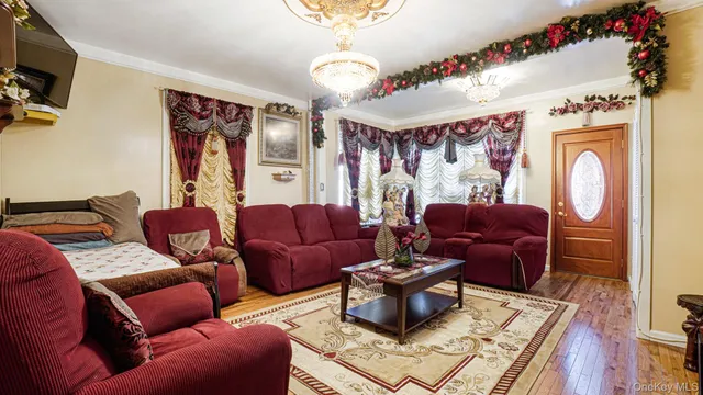 a living room with furniture a flat screen tv and a table