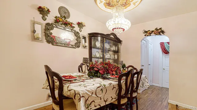 a view of a kitchen with a sink and dishwasher a stove top oven with wooden floor