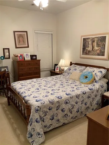 a bedroom with a bed and a dresser in it