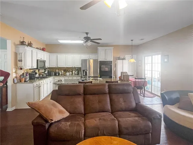 a living room with furniture and kitchen view