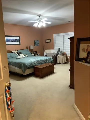 a bedroom with bed couch and window