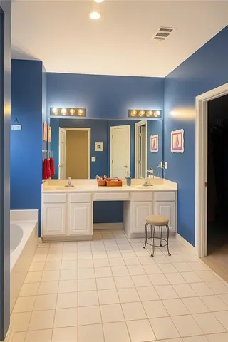 a bathroom with a sink a mirror and a bathtub