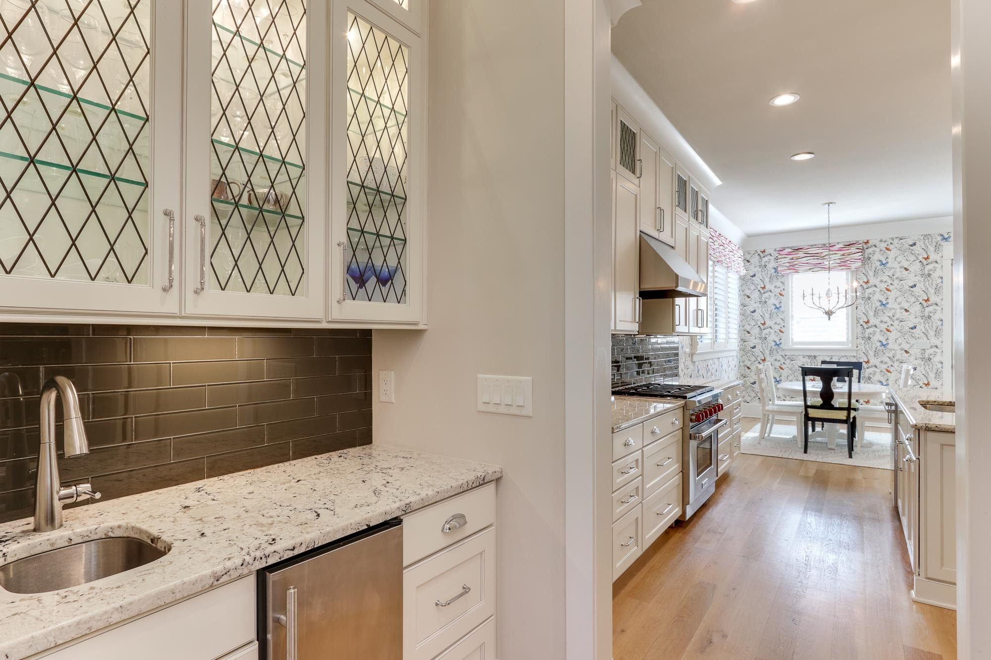 1302 Hedgelawn Way Raleigh, NC 27615 - Photo 6 of 38 Sunlight Filled Kitchen And Family Room. Gorgeous Lighted Cabinets In Butlers Pantry. Under Cabinet Lighting and Ice Maker. You Will Fall In Love With This Home And This Beautiful Subdivision. 1302 Hedgelawn Way