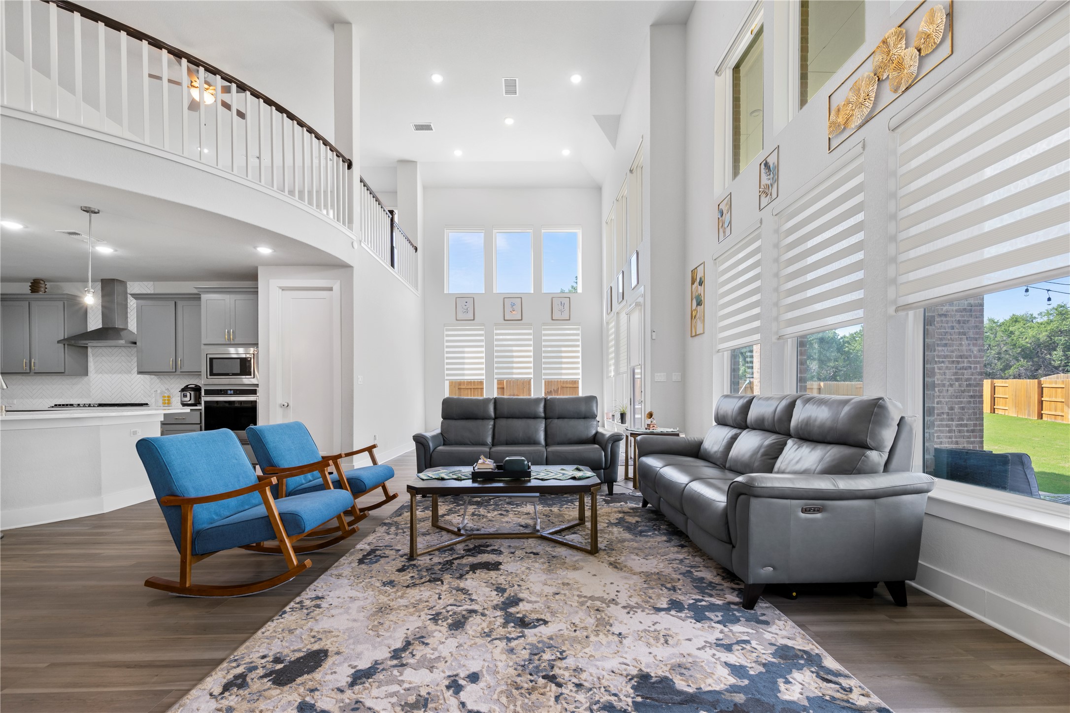 105 Autumn Oak Way Georgetown, TX 78628 - Photo 12 of 40 Soaring ceilings complement the expansive windows with layered shades