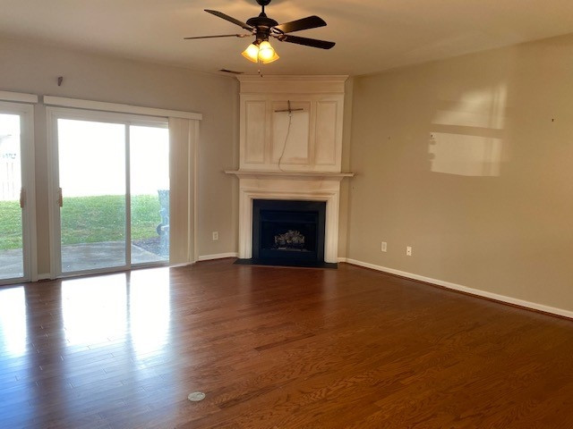4235 Vienna Crest Drive Raleigh, NC 27613 - Photo 3 of 11 a view of an empty room with wooden floor fireplace and a window