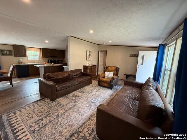 a living room with furniture flat screen tv and a table