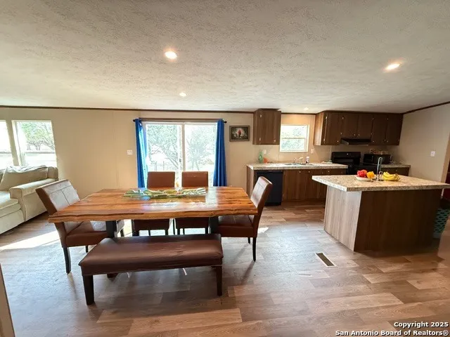a view of a dining room with furniture and window