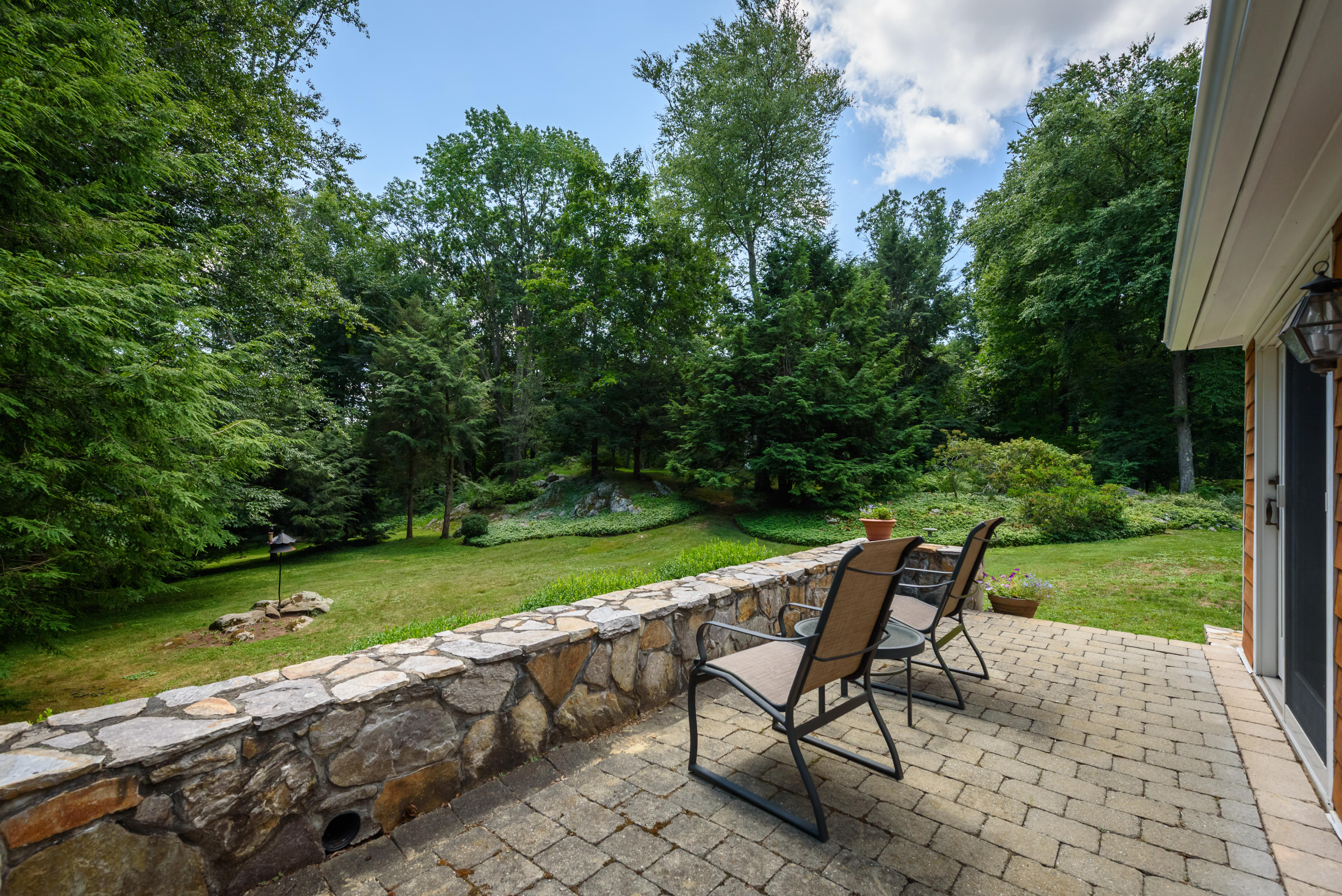 52 Boulderol Road Stamford, CT 06903 - Photo 16 of 18 a view of a chair and table on the garden