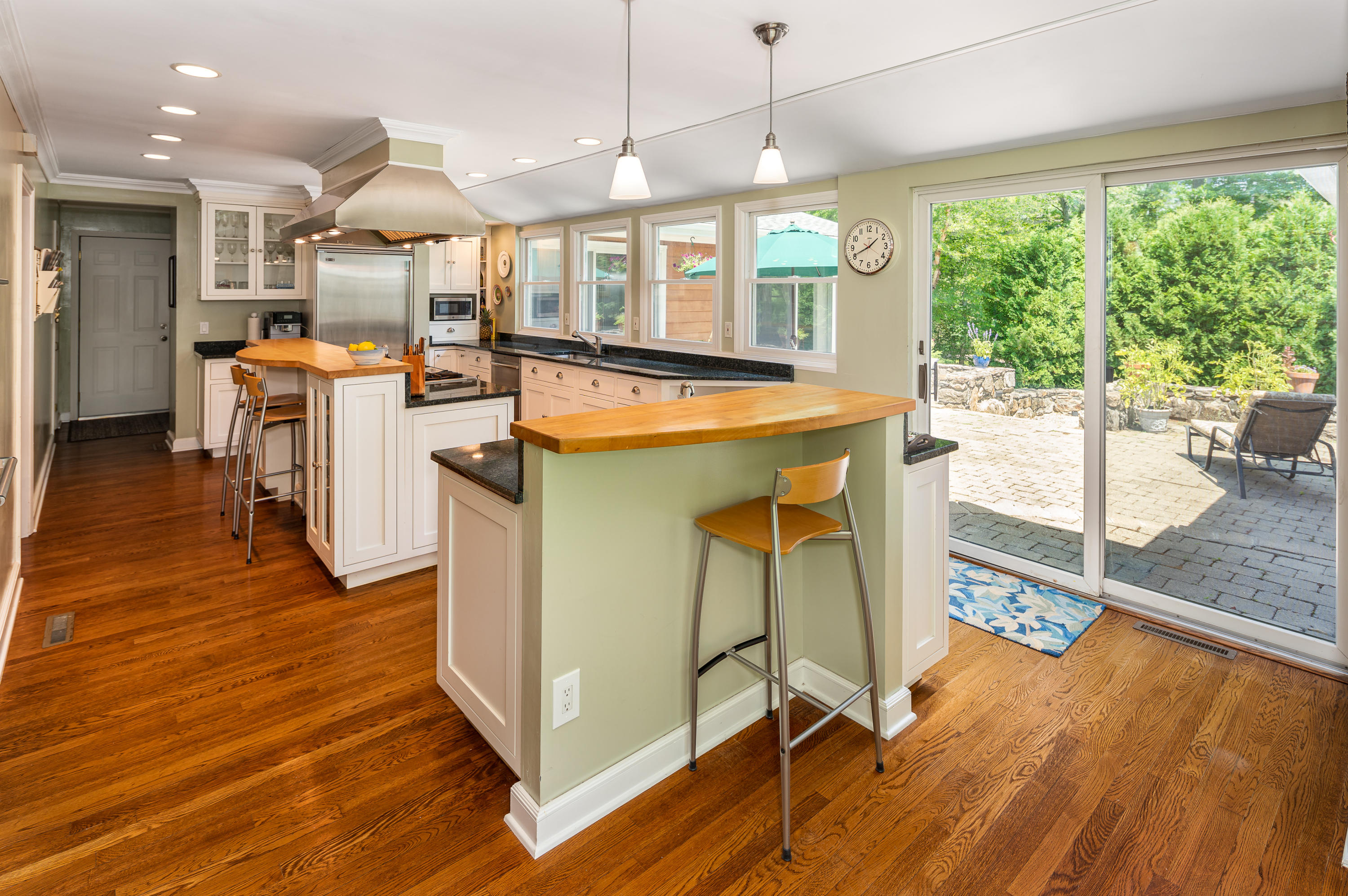 52 Boulderol Road Stamford, CT 06903 - Photo 4 of 18 a view of a kitchen with kitchen island a large counter top space a sink stainless steel appliances and cabinets