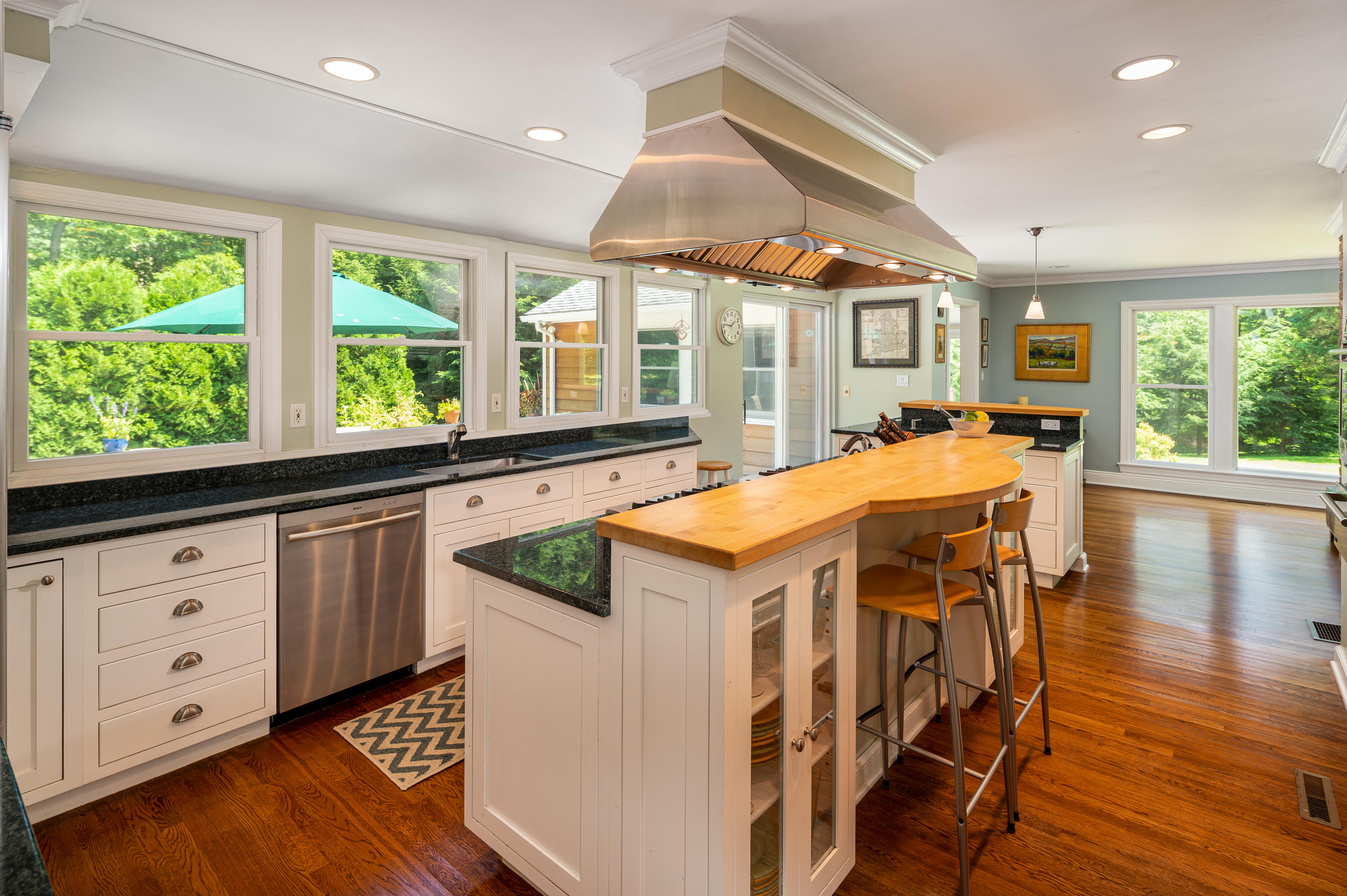 52 Boulderol Road Stamford, CT 06903 - Photo 5 of 18 a kitchen with stainless steel appliances kitchen island wooden floors and white cabinets