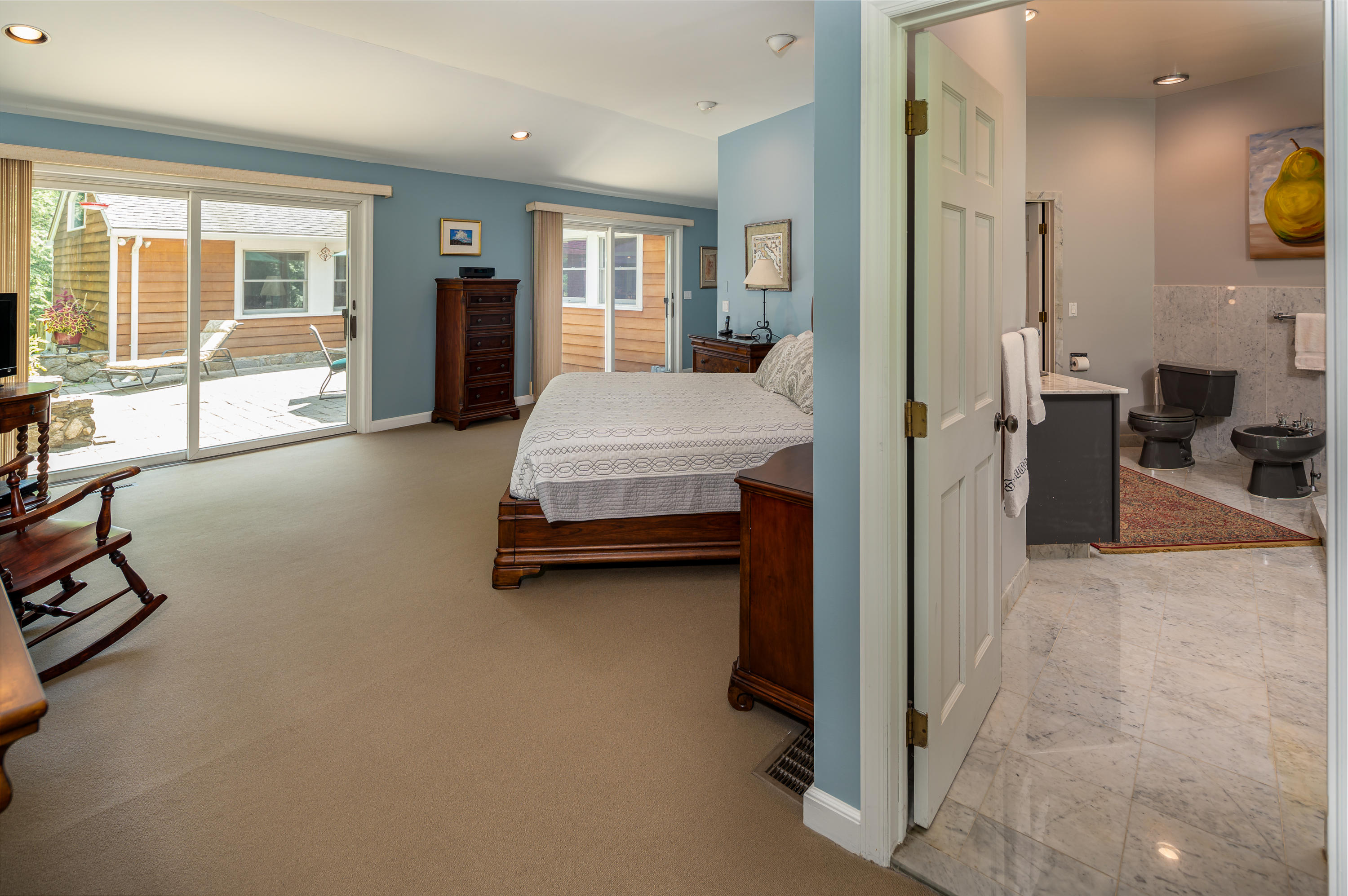 52 Boulderol Road Stamford, CT 06903 - Photo 9 of 18 a spacious bedroom with a bed and glass door