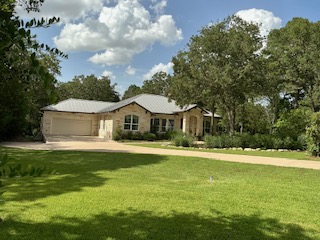 118 Loblolly Elgin, TX 78621 - Photo 2 of 31 An inviting stone and stucco facade welcomes you home, nestled amongst mature trees and lush green landscaping.