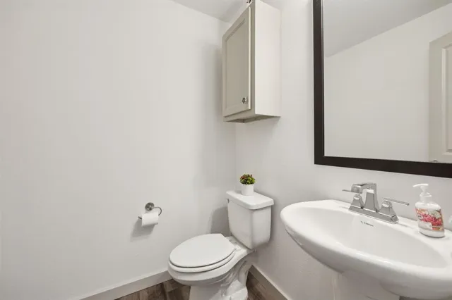 a bathroom with a sink a toilet and mirror