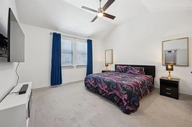 a bedroom with a bed a dresser and a window