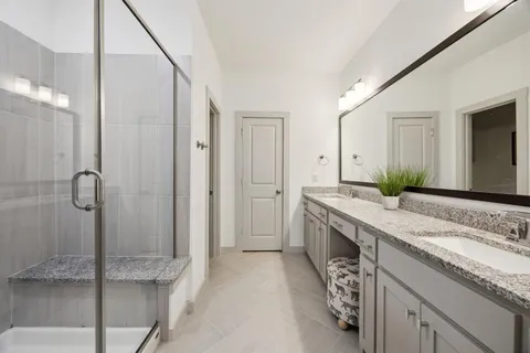 a spacious bathroom with a granite countertop sink and a mirror