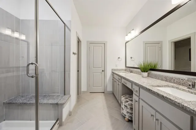 a spacious bathroom with a granite countertop sink and a mirror