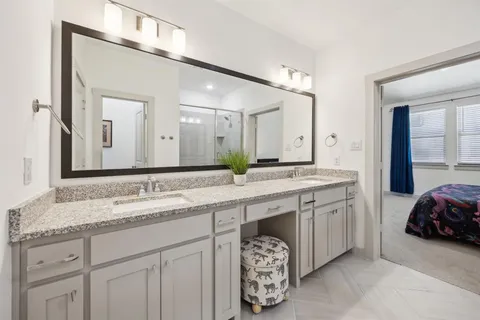 a spacious bathroom with a sink double vanity and a mirror