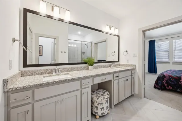 a spacious bathroom with a sink double vanity and a mirror