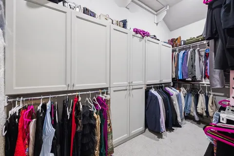 a view of walk in closet with clothes