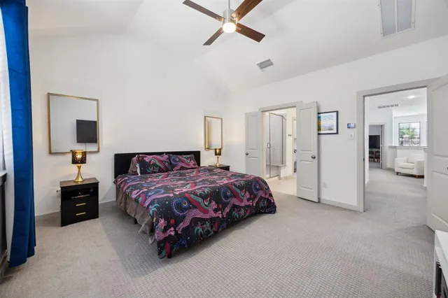 a spacious bedroom with a bed and cabinet