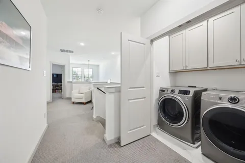 a view of a hallway with washer and dryer
