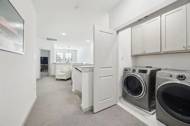 a view of a hallway with washer and dryer