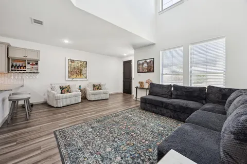 a living room with a couch and a rug