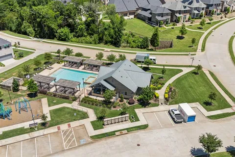 an aerial view of a house with a garden and lake view